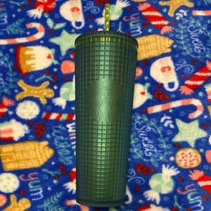 Solid green slightly stuffed Starbucks cup